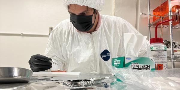 A picture of a person wearing PPO and working in a lab
